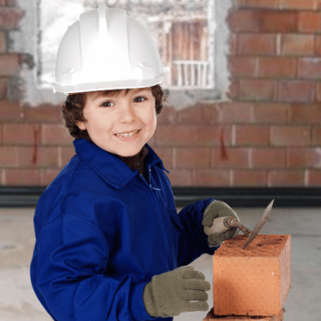 Young child trying bricklaying, representing firsthand experiences