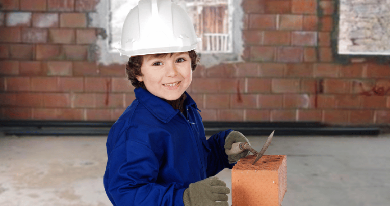 Young child trying bricklaying, representing firsthand experiences