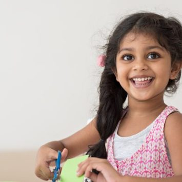 Happy girl in EYFS, representing personal, social and emotional development