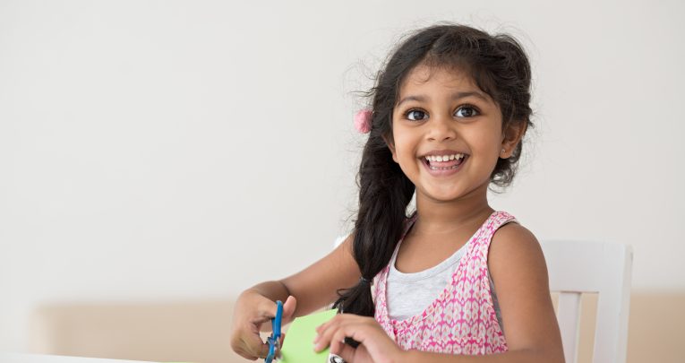 Happy girl in EYFS, representing personal, social and emotional development