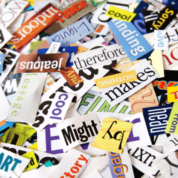 Ambitious vocabulary words cut out of magazines