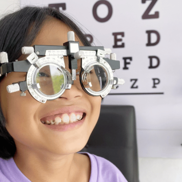 Girl wearing eye-test glasses, representing visual impairment support in schools