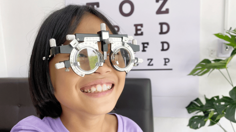 Girl wearing eye-test glasses, representing visual impairment support in schools