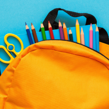 School supplies in yellow backpack