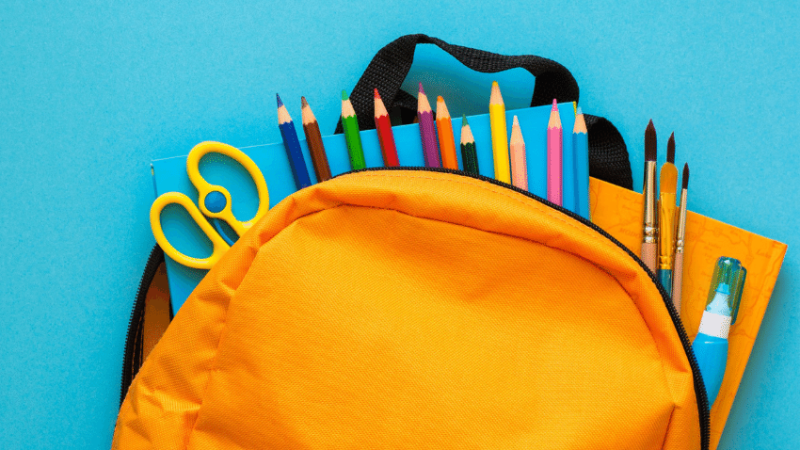 School supplies in yellow backpack