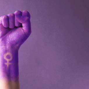 Fist painted purple, with feminine symbol, representing International Women's Day