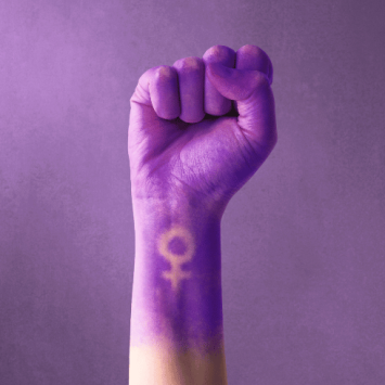 Fist painted purple, with feminine symbol, representing International Women's Day