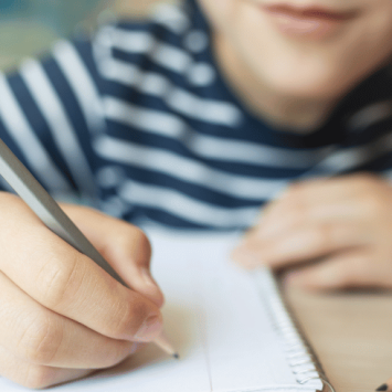 Kid doing greater depth writing in a notebook