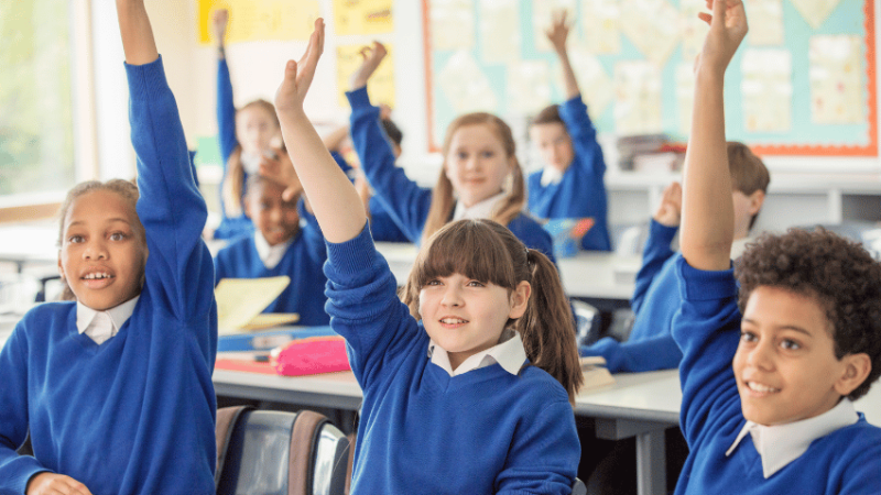 Schoolchildren raising their hands, representing working memory