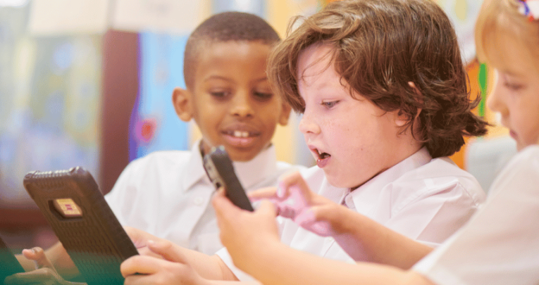 Children in school uniform doing collaborative learning