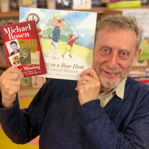 Author Michael Rosen holding up two of his books