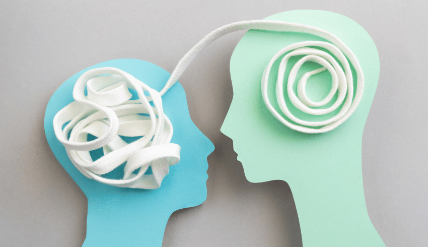 Two paper heads, linked together by white shoelace, representing relationships and sex education