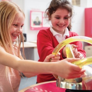 Two primary school children exploring an exhibit at Winchester Science Centre