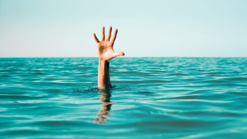 Waving hand in ocean, representing struggling early career teachers