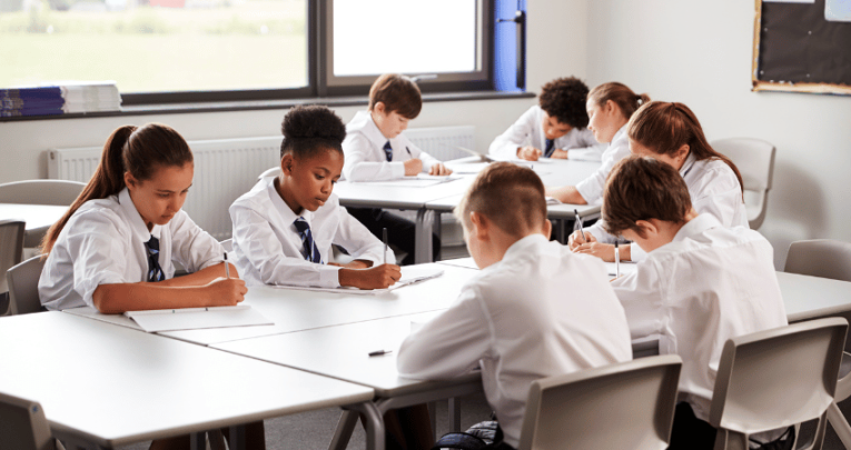 Secondary school students working at desks, representing Bloom's Taxonomy