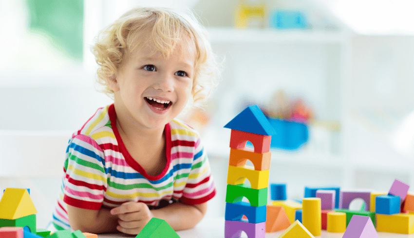 Boy building tower, representing Early Years activities