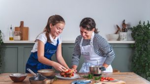 Student and pupil in Leiths aprons, preparing food