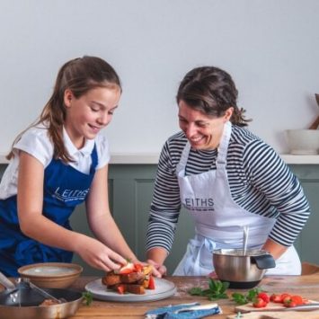 Student and pupil in Leiths aprons, preparing food