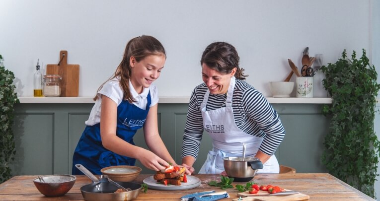 Student and pupil in Leiths aprons, preparing food