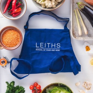 A Leiths Academy bag surrounded by fresh ingredients