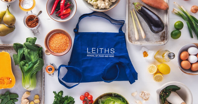 A Leiths Academy bag surrounded by fresh ingredients