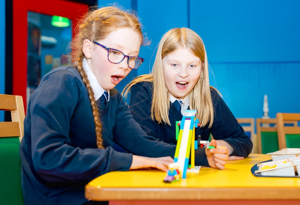 Two primary school girls make a LEGO model at LEGOLAND Discovery Centre workshop