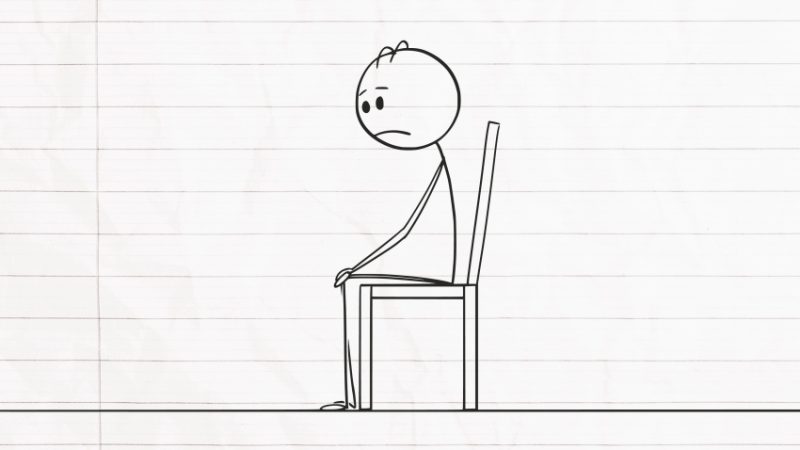 Stick figure drawing of upset figure sat in a chair, representing poor student mental health