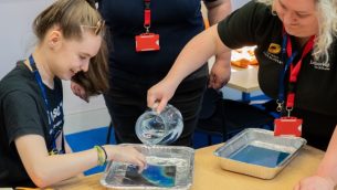 A secondary school girl taking part in a science experiment