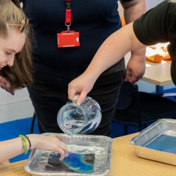 A secondary school girl taking part in a science experiment