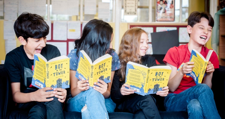 A group of school children reading books