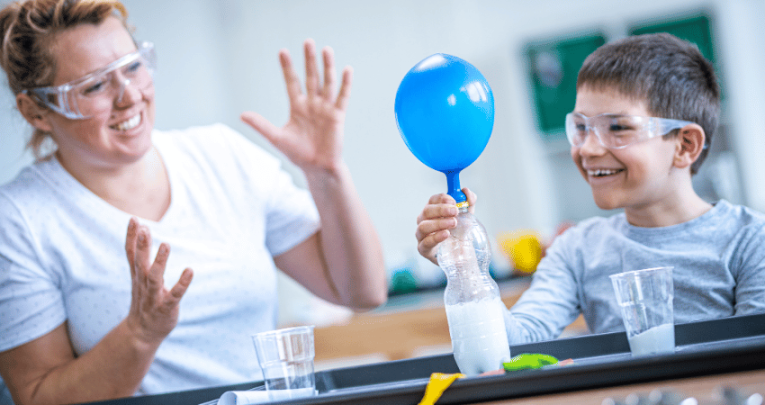 Teacher and pupil doing experiential learning with science experiment