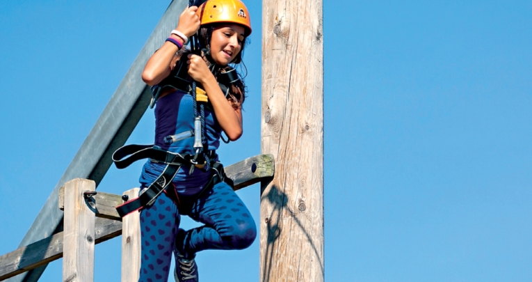 A school girl on a zip wire at a Kingswood centre