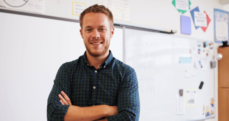 New teacher standing in front of whiteboard, representing Progress 8