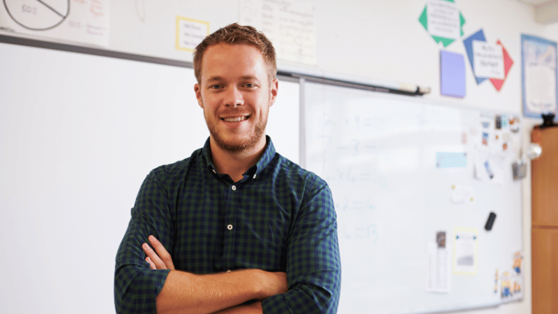 New teacher standing in front of whiteboard, representing Progress 8