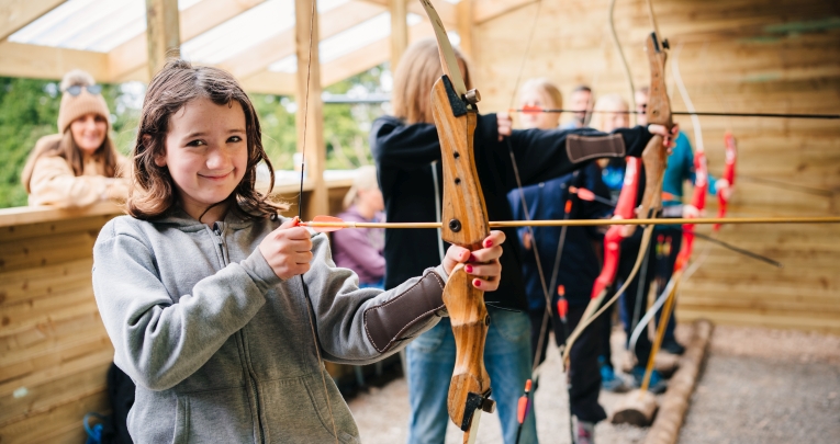 A school trying archery at Mendip Activity Centre