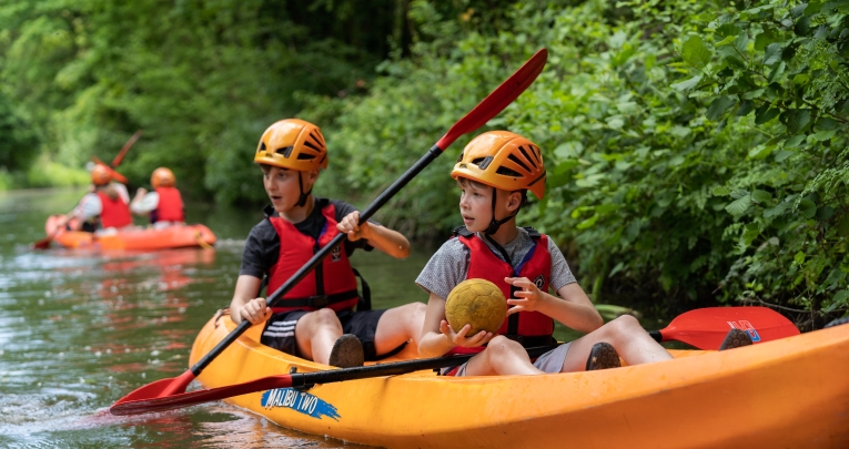 Two schoolboys in a kayak