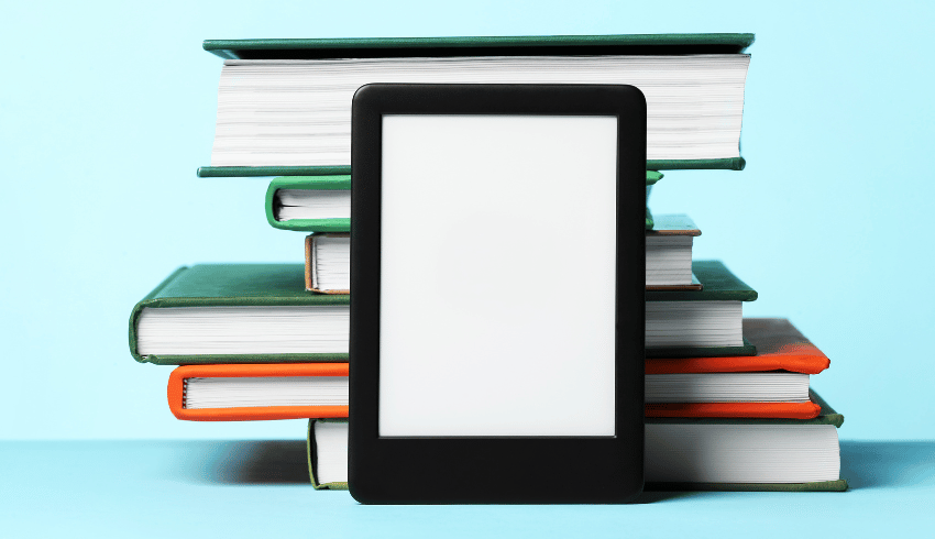 Ereader resting on pile of books