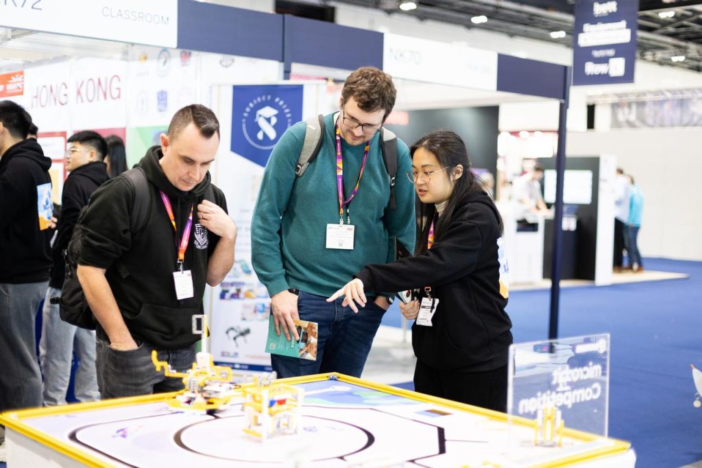 A teacher speaking to an exhibitor at Bett UK