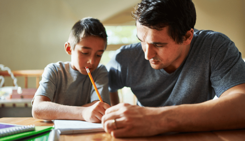 Father and son doing handwriting homework