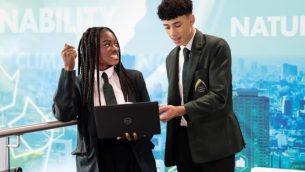 Two secondary school students looking at a laptop