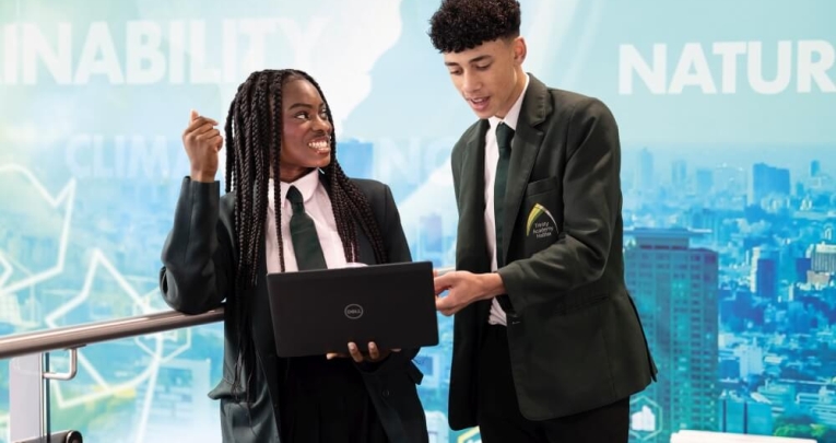 Two secondary school students looking at a laptop