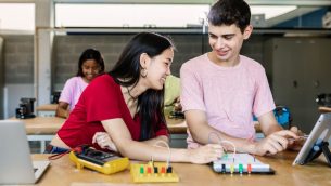 Two students in a technology classroom