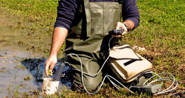 Man undertaking testing in a wet field, representing Green Careers Week