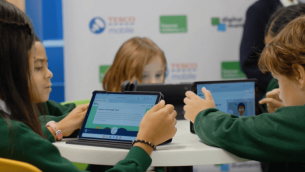 A group of primary school children looking at tablets