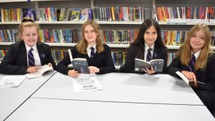 A group of secondary school girls sitting in a library