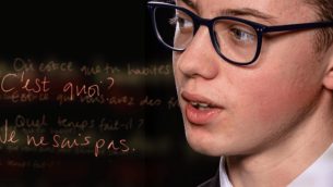 A schoolboy next to some French text