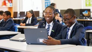 Two secondary school students working on a laptop